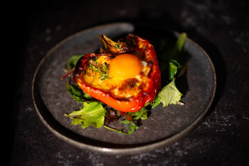 stuffed peppers with egg on dark background