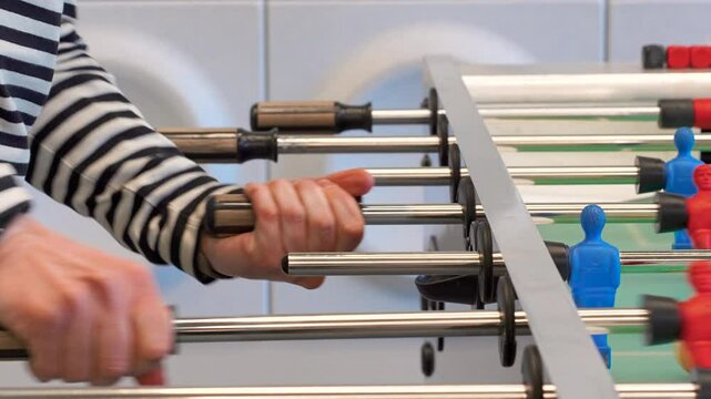 A man practices kicker table football throws, Recreation and leisure concept. Saint Petersburg, Russia - 6 Apr 2025