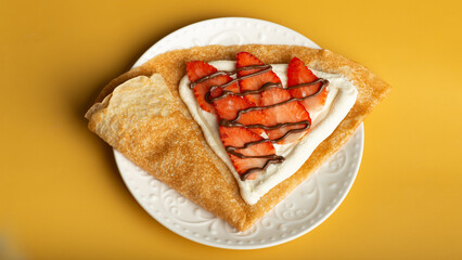 pancakes with strawberry and chocolate sauce