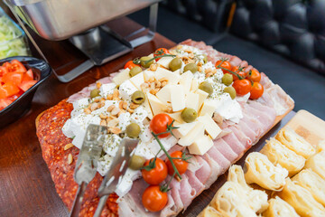 legant Assorted Cheese And Charcuterie Platter With Fresh Tomato And Nut Accents