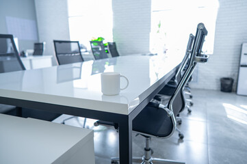 A table in a conference room without people. 