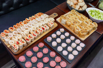 Elegant Canapés And Finger Foods With Salami, Bread, And Creamy Fillings