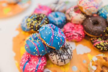 Pile of Colorful Donuts with Various Toppings: Sweet Indulgence and Treats