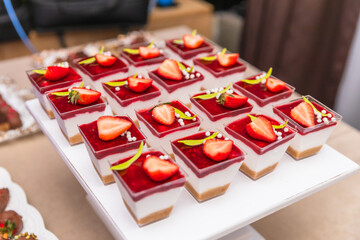 Elegant Strawberry Dessert Cups With Layers Of Cream, Biscuit, And Raspberry Sauce