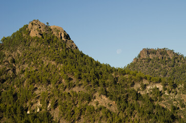 Morro de Pajonales and Morro de La Negra cliffs and full moon. Integral Natural Reserve of Inagua. Tejeda. Gran Canaria. Canary Islands. Spain.