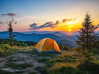 Fotobehang Stunning sunset over mountains with tent in serene camping spot © CaptureCollabStudios
