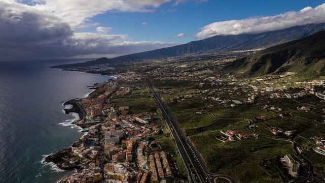 Beautiful aerial timelapse of candelaria town, located on the coast of tenerife in the canary islands, spain, showcasing the changing light and shadows over the landscape