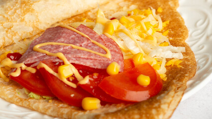 thin pancakes with tomato and cheese filling. serving salty food on yellow background. Thin pancakes with fillings