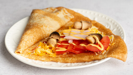 thin pancakes with tomato and cheese filling. serving salty food on yellow background. Thin pancakes with fillings