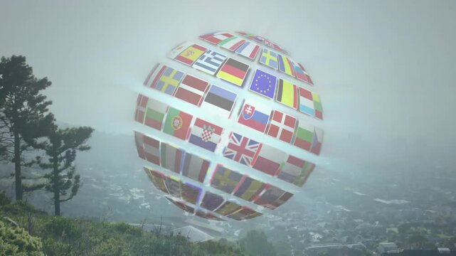 Rotating animation of globe with flags over misty landscape in school setting