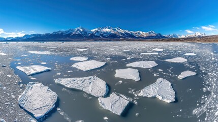 Majestic Glacial Landscape with Icebergs and Snow-Capped Mountains Under Clear Blue Sky