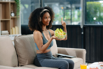 Woman enjoys a fresh salad with fruits and juice, embodying wellness, nutrition, and vitality