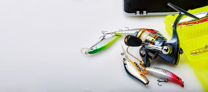 concept of advertising banner on fishing theme, fishing tackle on white background, place for text