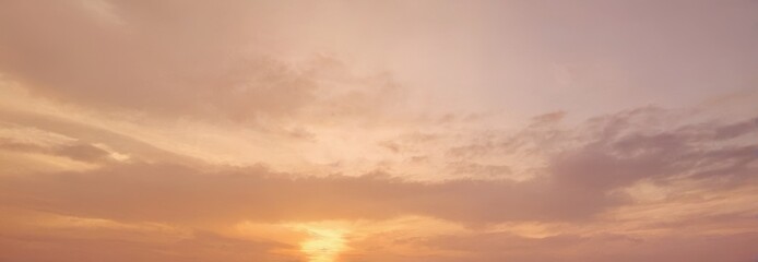 Fototapeta premium Sunset with soft clouds and warm light in the sky.