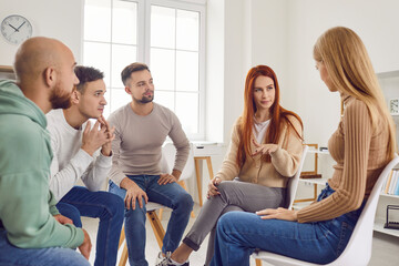 Group therapy session where a psychologist guides a circle of people through discussions, fostering...