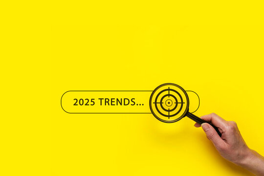 Trends 2024 year concept. Hand holding magnifying glass with 2024 trend searching bar for optimization 2024 business marketing trends and business plan in new year. Find information and new ideas.