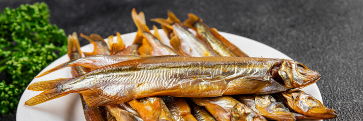 Smoked fish capelin sprat fresh dish gourmet food background on table rustic food top view copy...