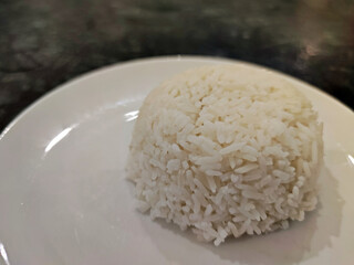 Thai Jasmine rice (White rice), plain rice in white dish on wooden table.