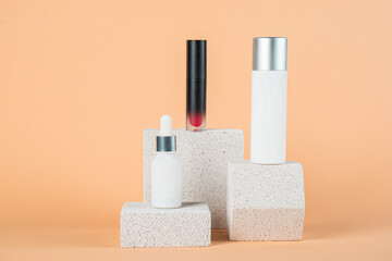 Plastic white tube for cream or lotion. Skin care or sunscreen cosmetic with stylish props on cream background.