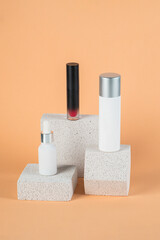 Plastic white tube for cream or lotion. Skin care or sunscreen cosmetic with stylish props on cream background.