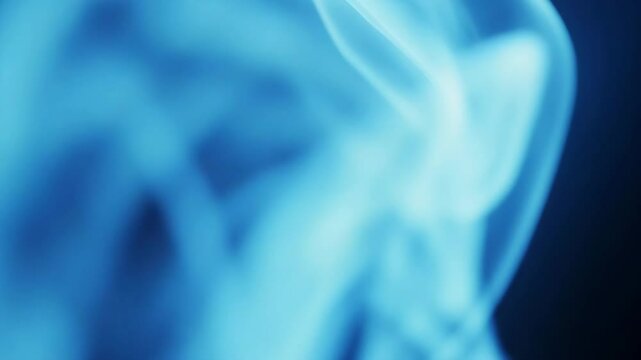 Soft abstract blue smoke flowing on dark background, ideal for mystical, meditative, artistic, and atmospheric video backgrounds or design overlays.

