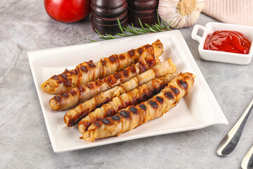 Grilled meat sausages wrapped bacon