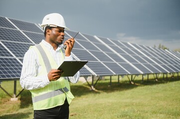 African american technician check the maintenance of the solar panels. Black man engineer at solar...