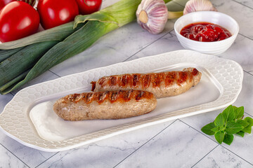 Grilled pork sausages served tomato sauce