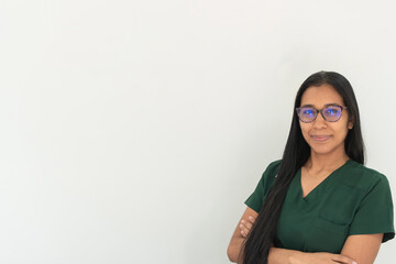 Confident latin nurse posing with crossed arms in hospital setting