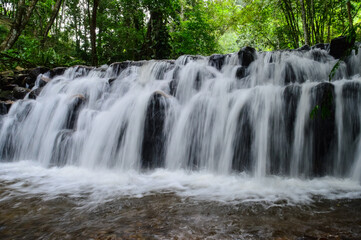 Obraz premium Beautiful Small Waterfall in Green Forest in jungle