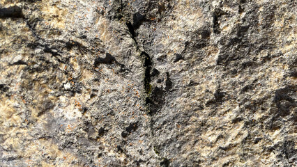 Grey stone wall with cracks. Texture Background. Closeup