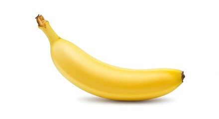 Single yellow banana in focus on a white background ripe fruit shown in natural lighting isolated