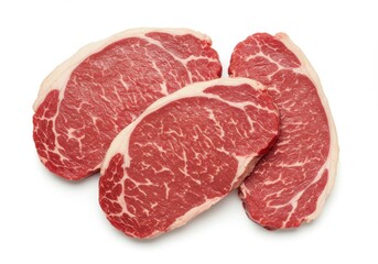 Three raw ribeye steak cuts with marbled texture isolated neatly on a bright white background surface