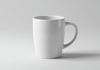 Obraz premium Plain white ceramic mug on a light gray background with handle visible on the right side view