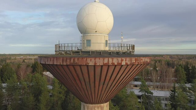 Vantaa.Finland-November 6.2020: The white big ball on top of the water tower in Vantaa Finland on an aerial view being surrounded with lots of trees. geology shot.4k