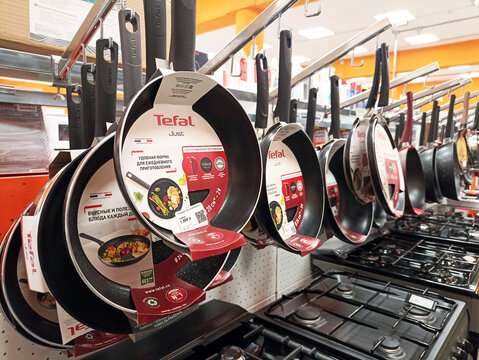 Display of tefal nonstick frying pans in kitchen appliance store