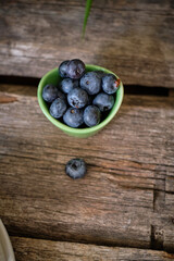 blueberries in a bowl on wooden background