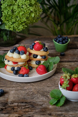 Mille-feuille cake of homemade puff pastry with strawberries and blueberries