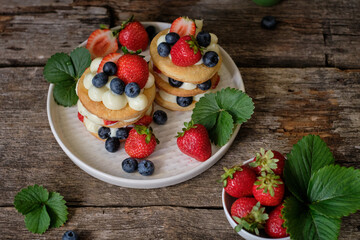 Mille-feuille cake of homemade puff pastry with strawberries and blueberries
