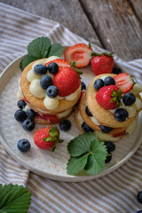 Mille-feuille cake of homemade puff pastry with strawberries and blueberries