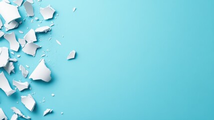 Abstract shattered ceramic pieces on a vibrant blue background for creative design or artistic projects