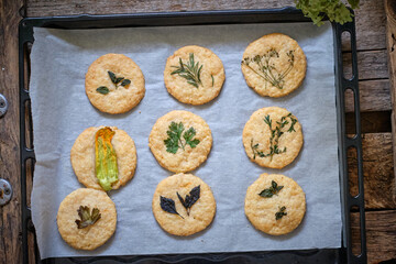 cheese cookies with different types of aromatic herbs, edible flowers