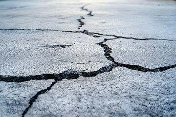 Cracked concrete surface with visible deep fissures