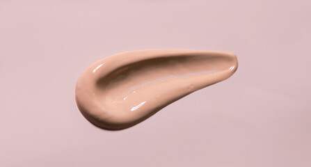 Makeup foundation smear, smudge BB cream sample, cosmetic product on pastel background. Make up base skin care, foundation, concealer close up. Skin corrector beauty facial treatment stroke. Top view