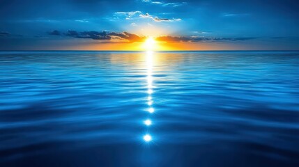 Blue ocean reflects a brilliant setting sun.