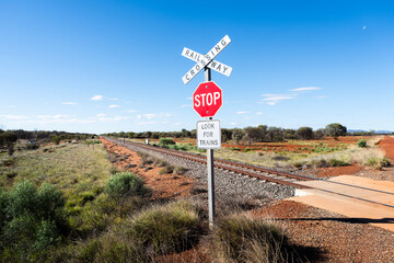 Railway crossing sign along the Adelaide–Darwin rail corridor in a remote part of the Australian...