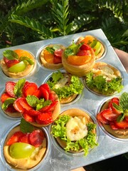 A delicate fruit tart with a golden buttery crust, creamy custard filling, and an array of colorful fresh fruits. A perfect dessert for a refreshing and elegant treat.