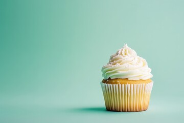 A single frosted cupcake rests elegantly on a solid colored background