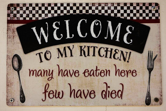 Humorous kitchen decor sign with playful text about food and safety