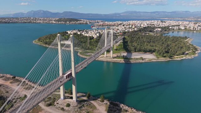 Wide panoramic shot of the Chalkida High Bridge on a sunny day, with the city in the background. Clear skies and scenic coastal view highlight urban and structural beauty
